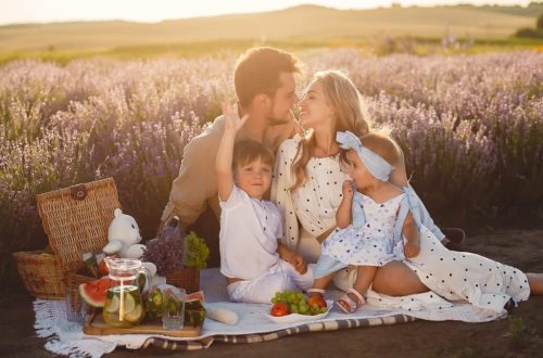 A joyful family picnic in a lavender field, capturing togetherness and love at sunset.